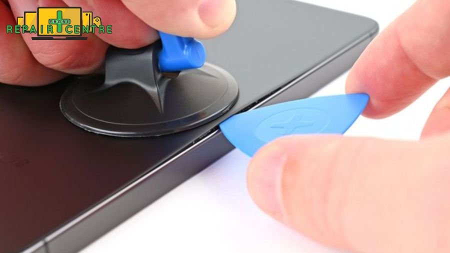 Use the suction cup and plastic pry tools to lift the cracked screen